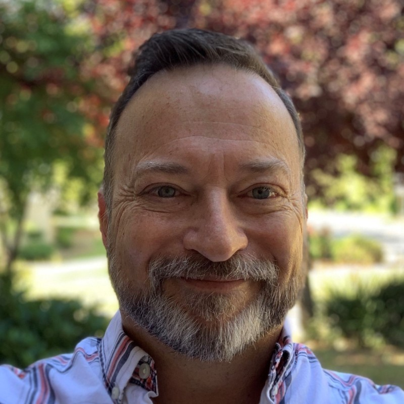 Rick_Anderson posing for a photo with a bright smile on his face